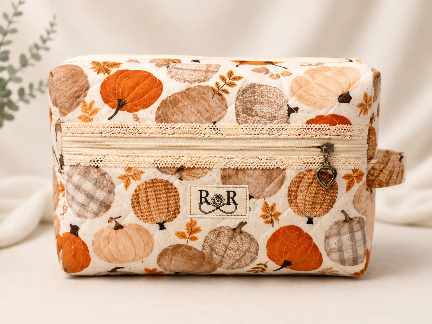 Quilted personal care bag with orange and neutral pumpkin print and R and R Creative Co fabric label