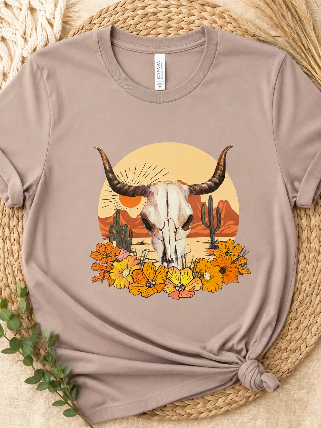 Taupe custom T-shirt featuring a western longhorn skull with desert florals and cacti